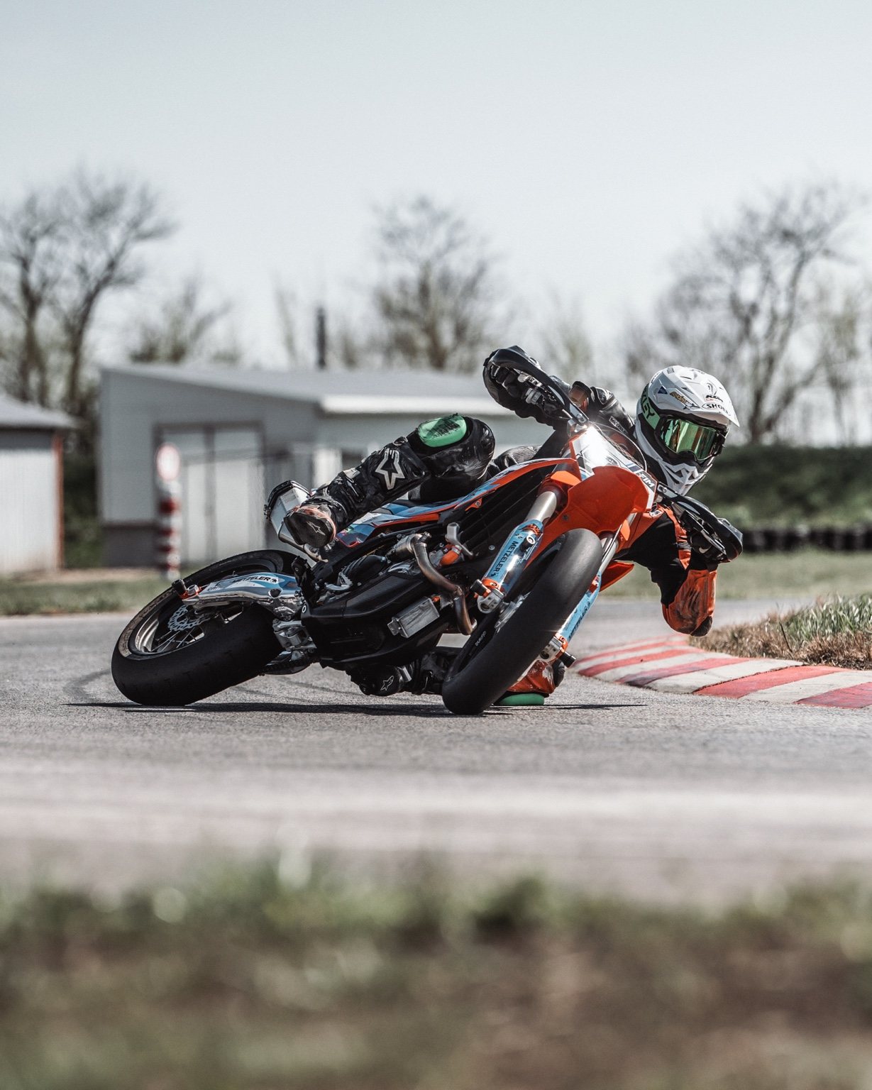 Motorbike rider leaning into a corner — sport series cover
